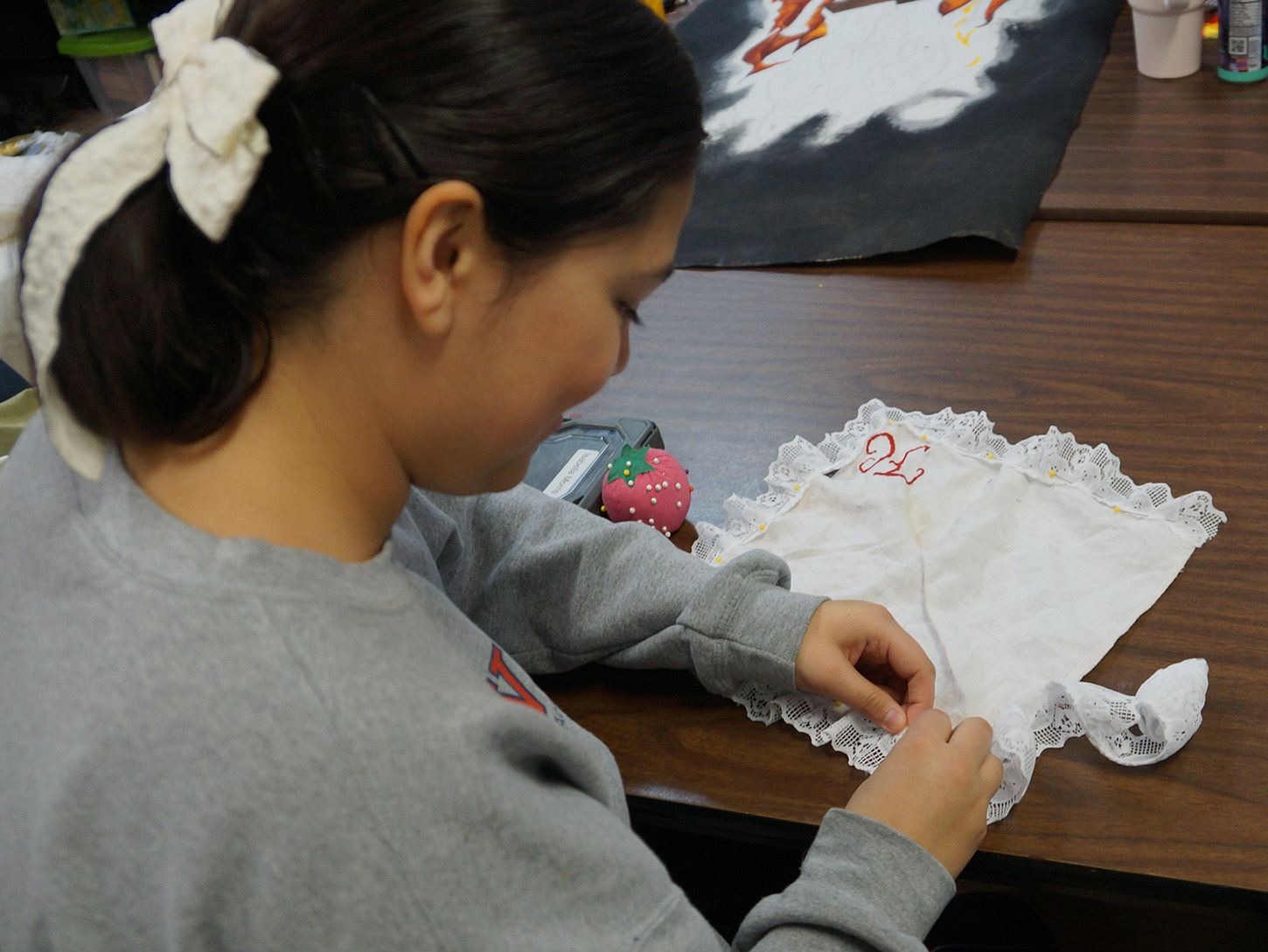 Young student sewing in class at TCA+A's Fine Arts in Fort Worth